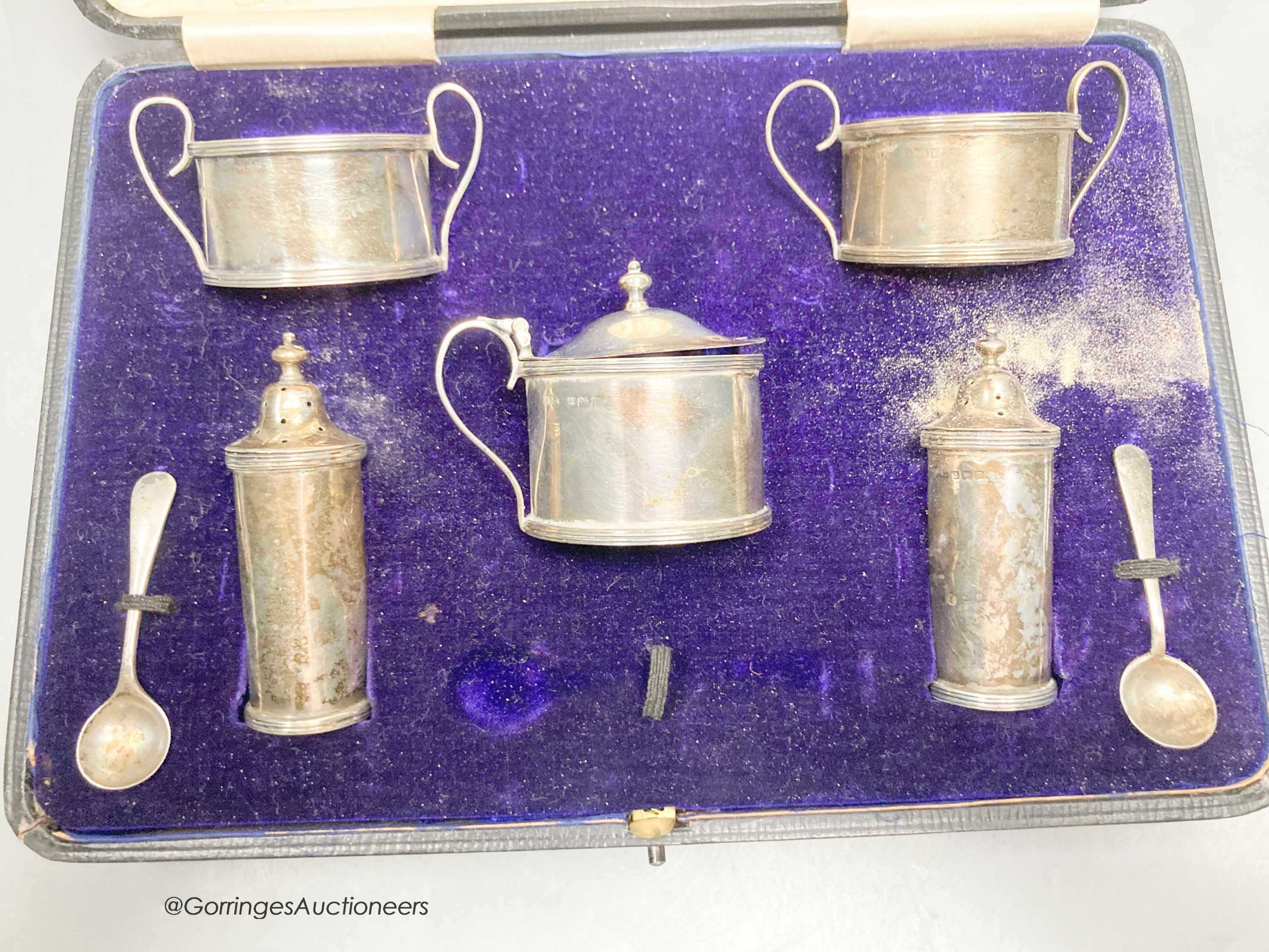 A cased George V silver five piece condiment set and two spoon, Birmingham, 1912.